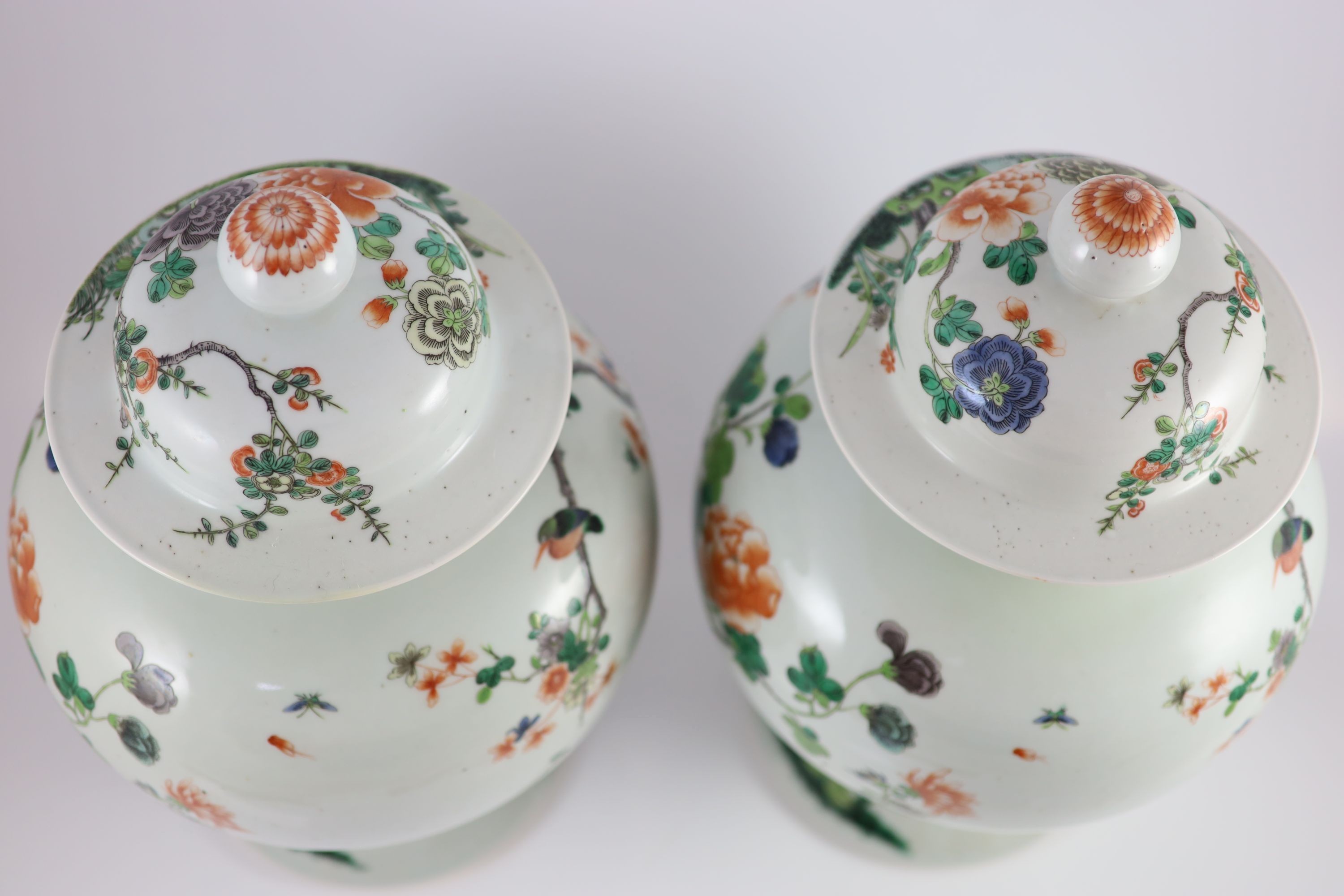 A pair of large Chinese famille verte jars and covers, late 19th century, 45cm high, restorations